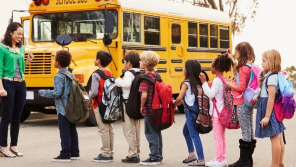 Children line up at school bus